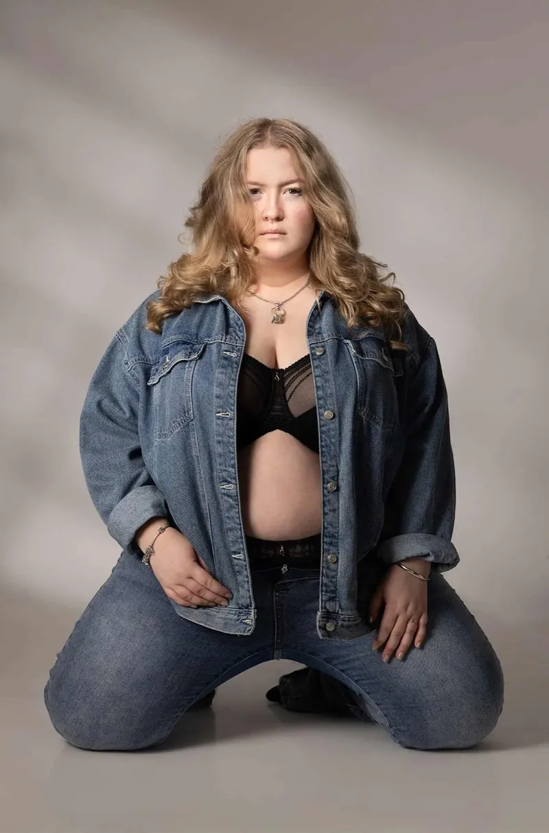 Confident boudoir portrait wearing an oversized denim jacket